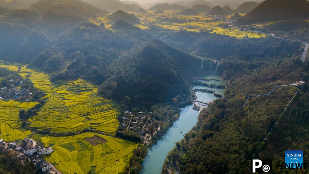 Tourists have fun at scenic area of Jiulong Waterfalls in SW China