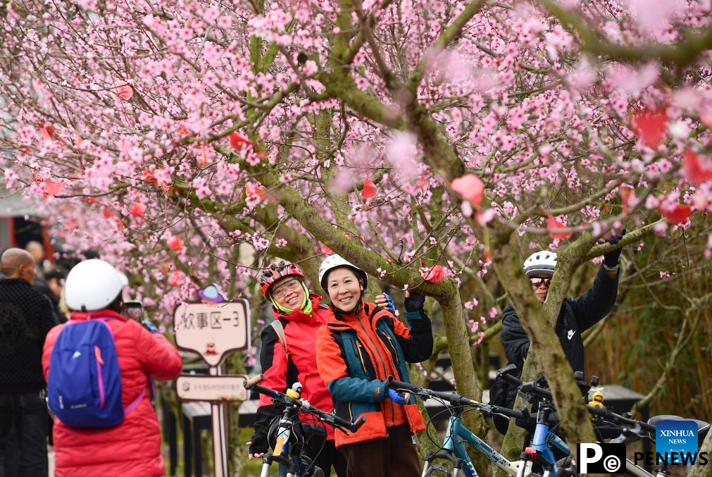 People enjoy spring blossoms across China