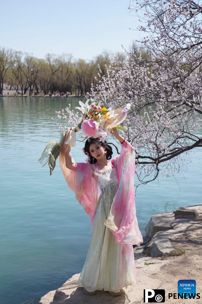 Tourists enjoy blossoms at Summer Palace in Beijing